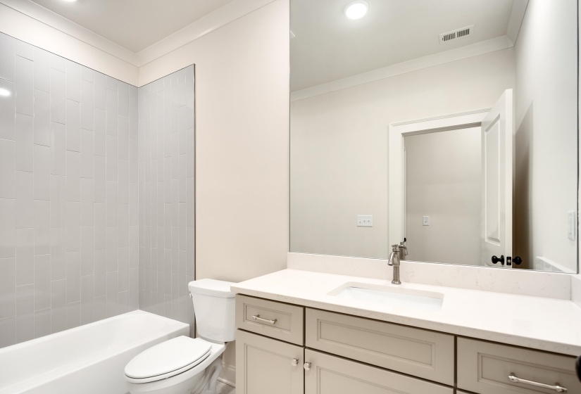 Bathroom featuring crown molding, toilet, vanity, washtub / shower combination, and recessed lighting