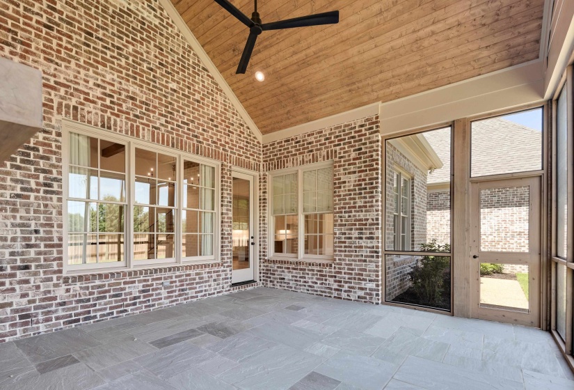 Unfurnished sunroom featuring ceiling fan, lofted ceiling, and plenty of natural light