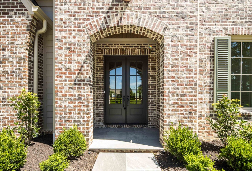 Doorway to property with french doors and brick siding