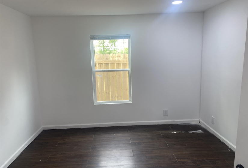Bedroom featuring baseboards, recessed lighting, and dark wood-style flooring