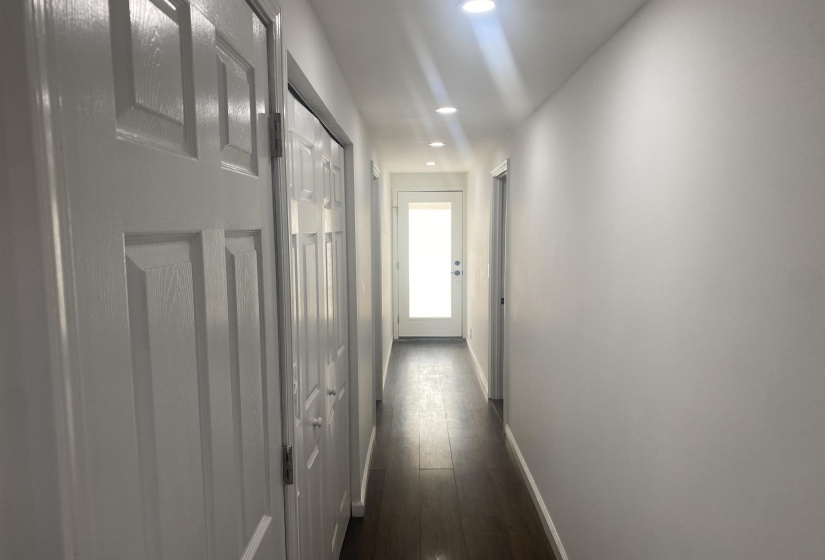 Hallway featuring baseboards, recessed lighting, and dark wood finished floors