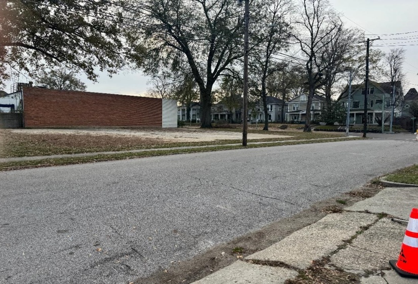 View of asphalt road with sidewalks, a residential view, and curbs
