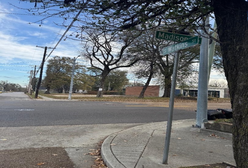 View of asphalt road with curbs and sidewalks