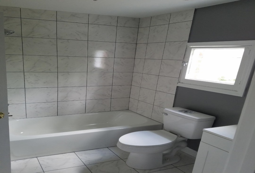 Bathroom with vanity and marble finish flooring