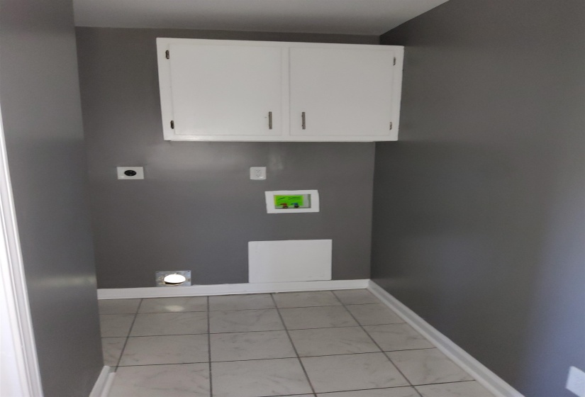 Laundry area featuring hookup for a washing machine, hookup for an electric dryer, and cabinet space