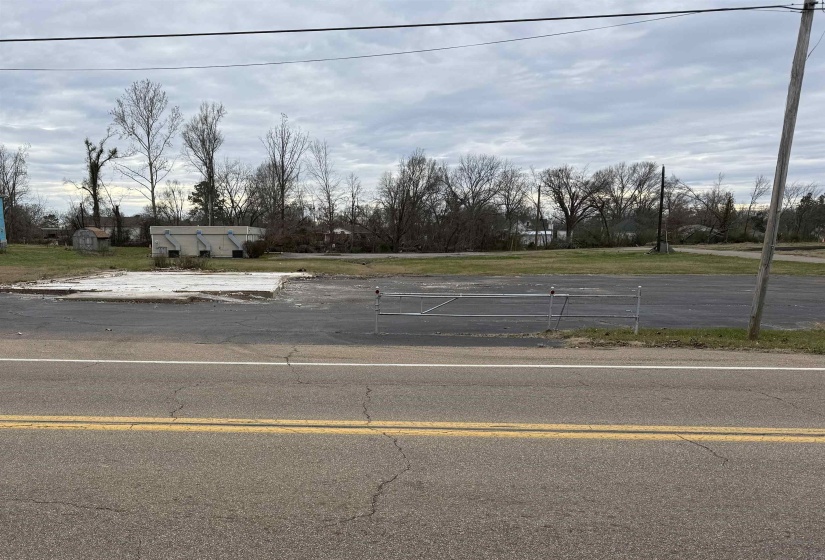 View of asphalt road with view of wooded area