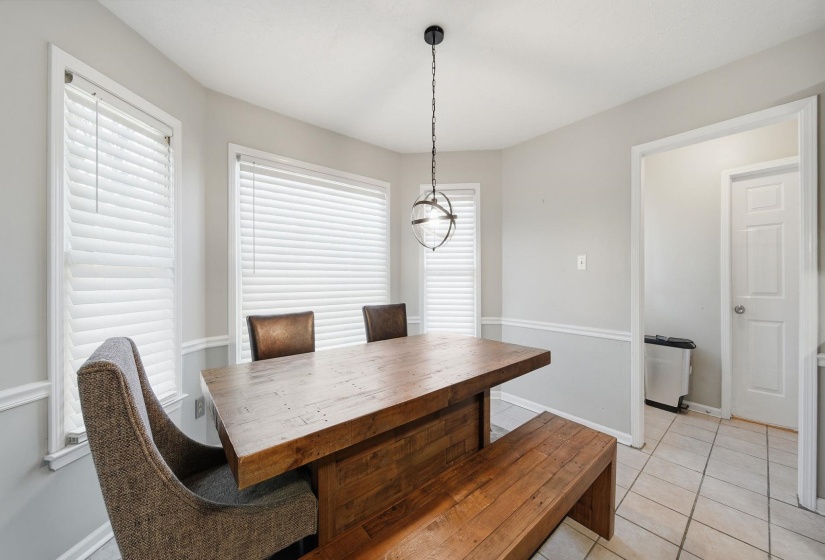 Dining area with light tile patterned floors and baseboards