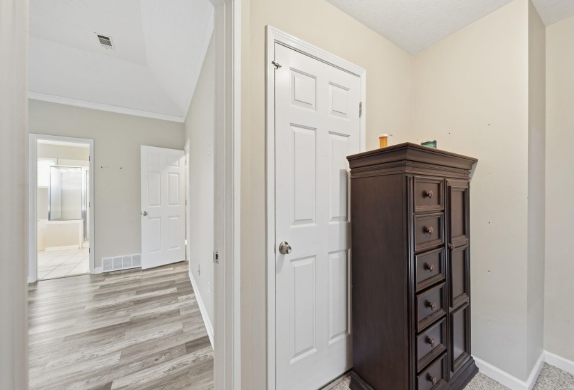 Hallway with baseboards and light wood-style floors