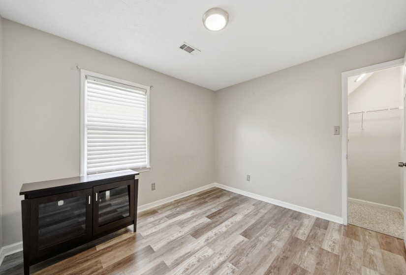 Unfurnished bedroom featuring light wood-type flooring and a walk in closet