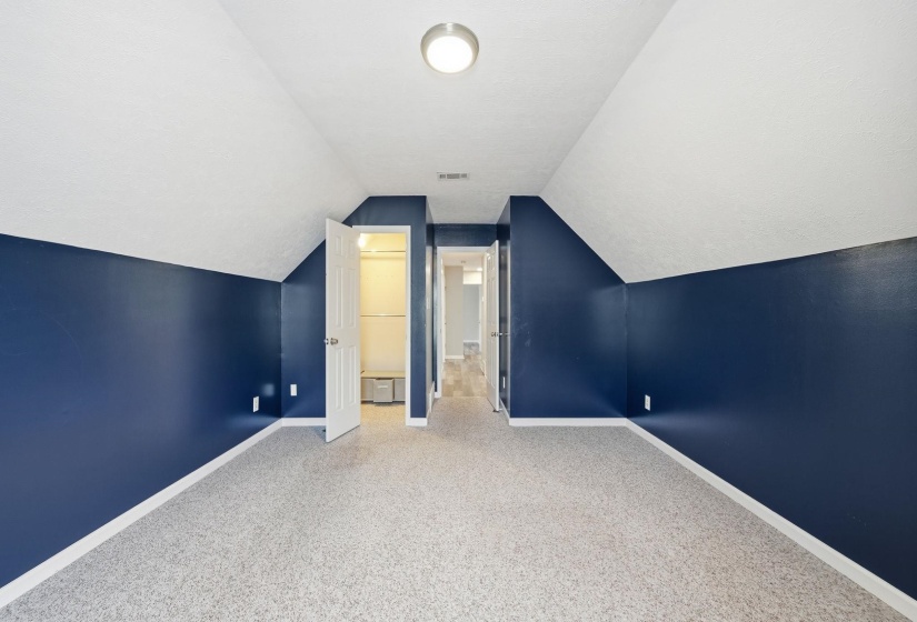 Bonus room with vaulted ceiling and carpet floors