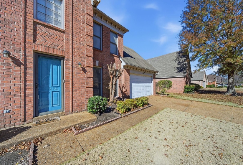 View of side of home with brick siding and driveway