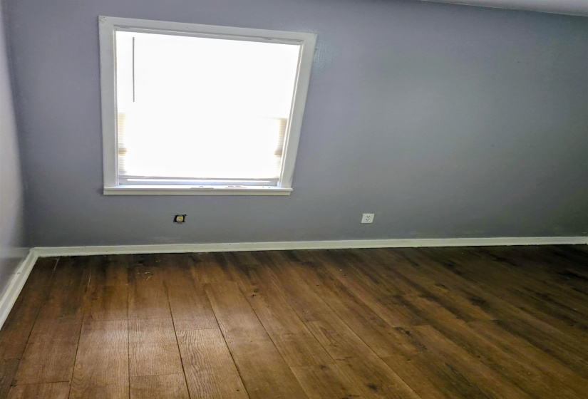 Unfurnished room with dark wood-style floors and baseboards