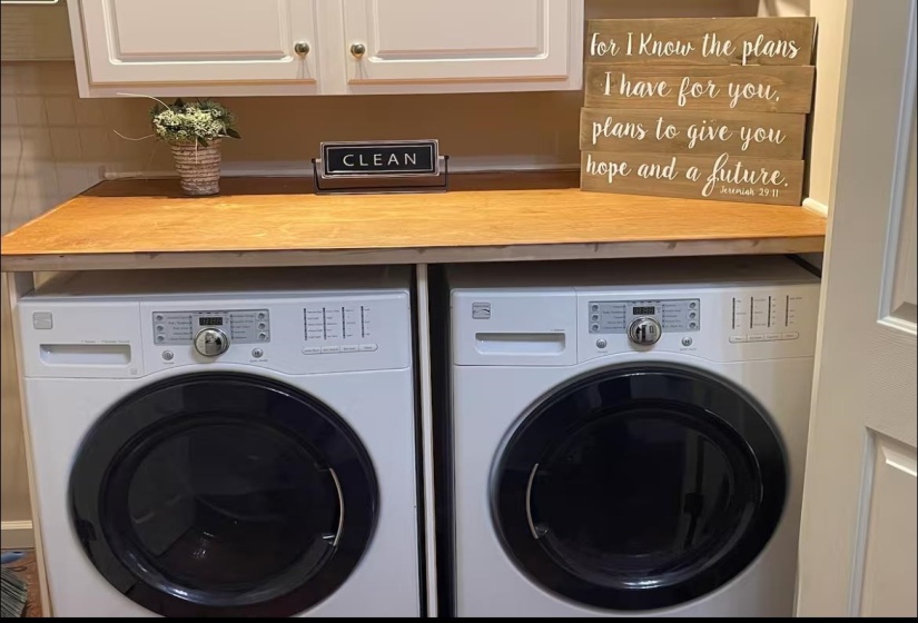 Laundry room with cabinet space and washer and dryer