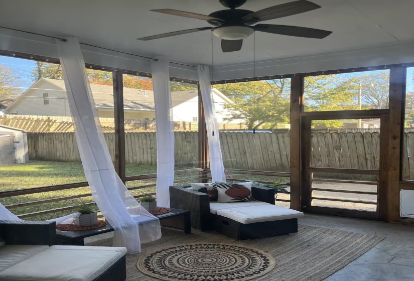 Sunroom / solarium featuring plenty of natural light, an outdoor living space, and ceiling fan
