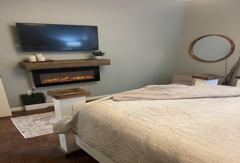 Bedroom with a glass covered fireplace