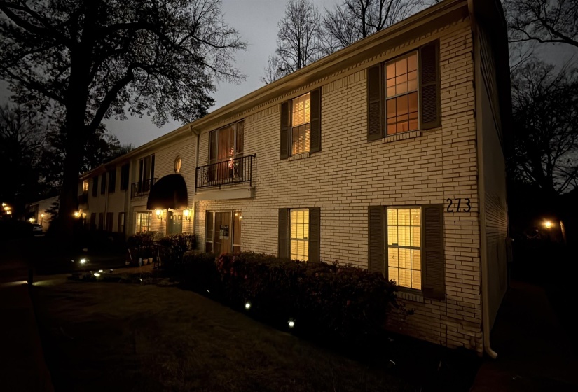 Colonial home featuring a balcony and brick siding