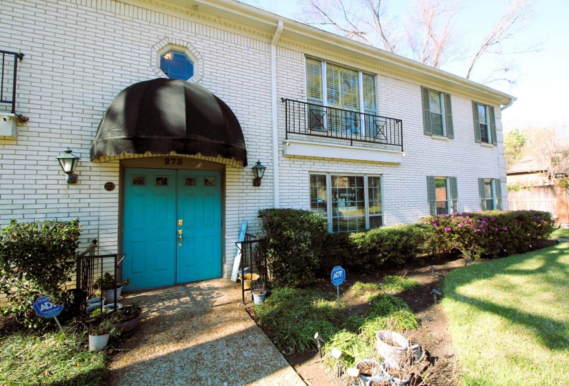 View of exterior entry with brick siding