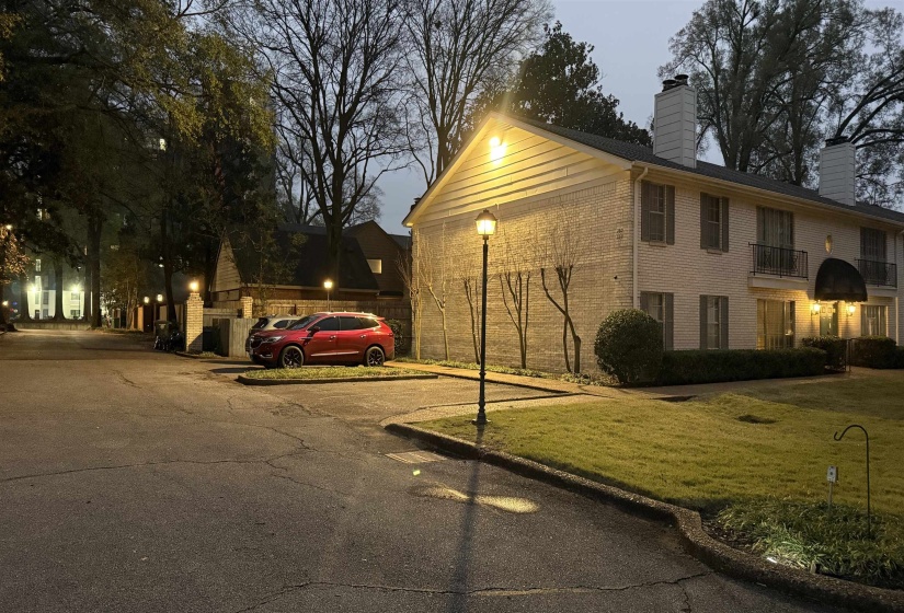 View of side of home with a chimney, a lawn, and brick siding