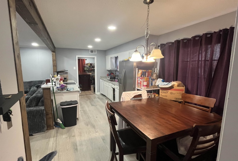 Dining space featuring a chandelier, light wood finished floors, and recessed lighting