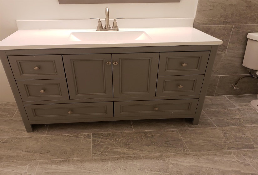 Bathroom featuring tile walls and vanity