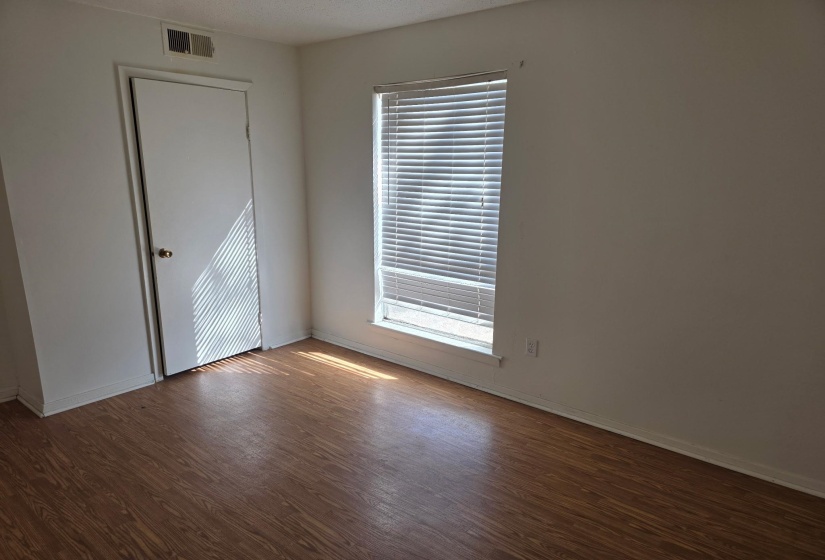 Unfurnished room with dark wood-style flooring and baseboards
