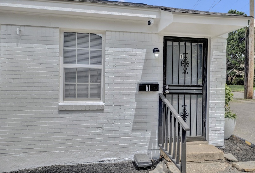 Doorway to property with brick siding