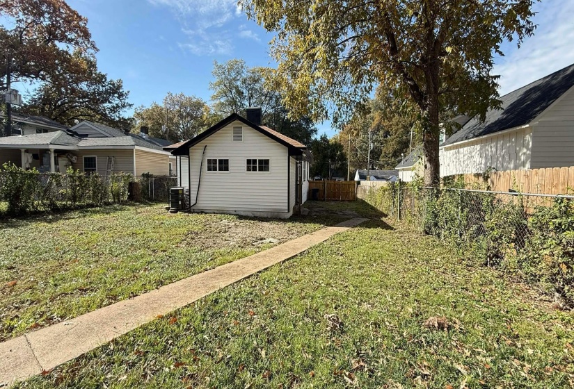 View of side of property with a fenced backyard and a cooling unit