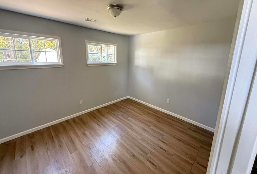 Empty room featuring baseboards and light wood finished floors