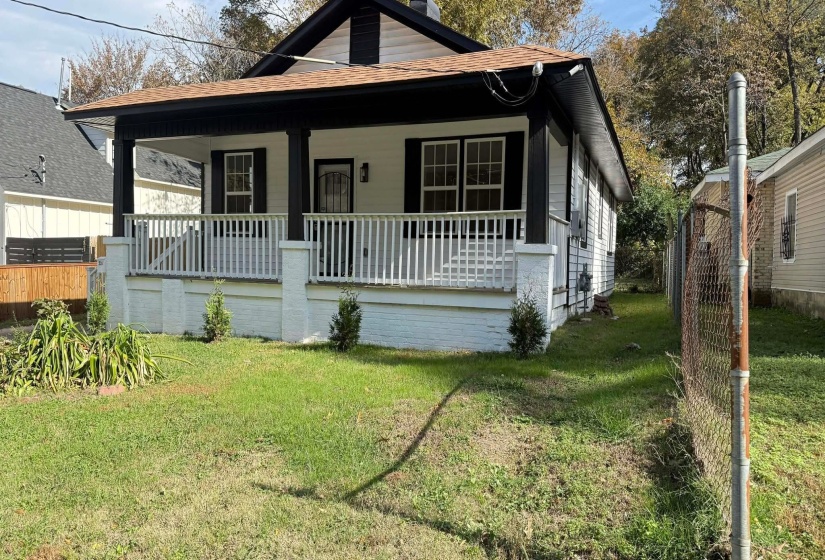 Bungalow-style house with a front lawn, covered porch, and a shingled roof