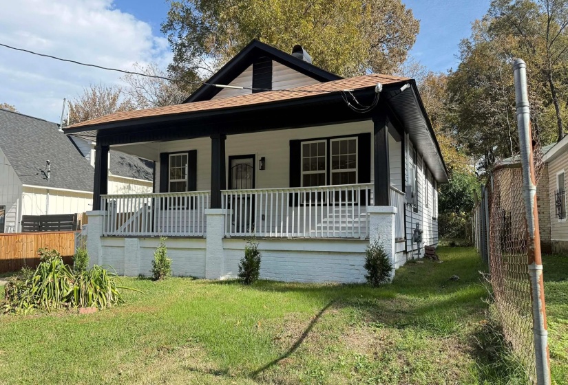 Bungalow-style home with covered porch and a front yard
