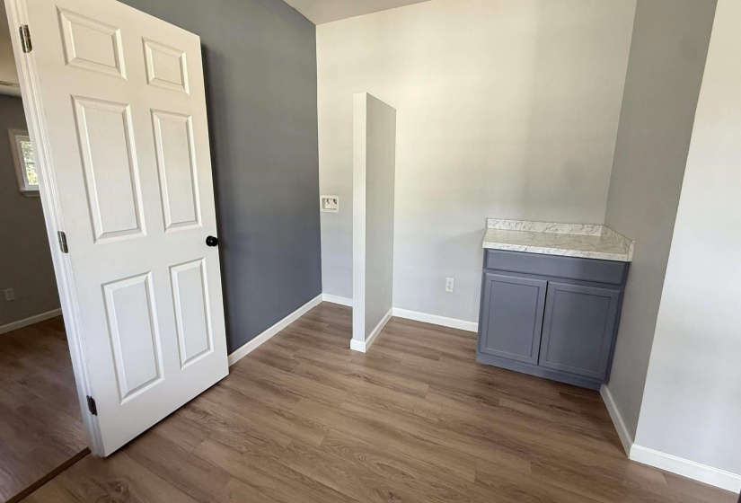 Hall with baseboards and dark wood-style flooring