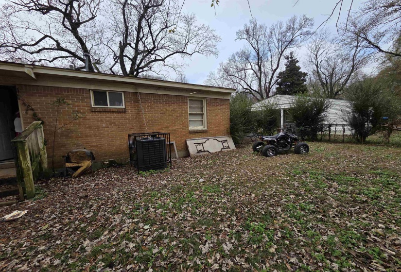 View of property exterior with brick siding