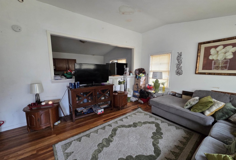 Living room with lofted ceiling and wood finished floors