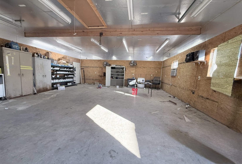 Workshop interior. Features garage door snd side door entrace