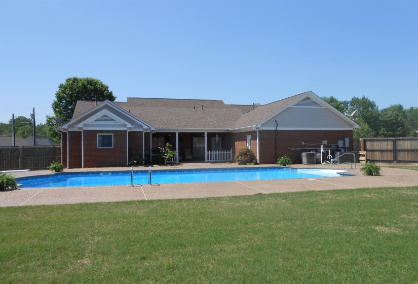 View of swimming pool featuring a fenced backyard and patio surround