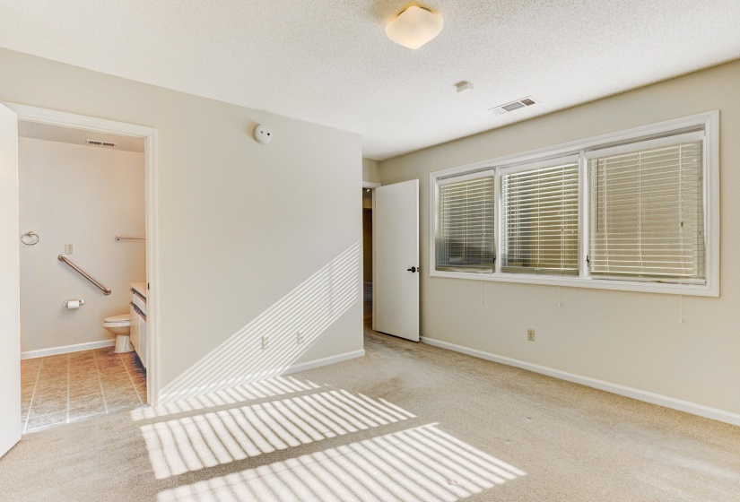 Empty room featuring a textured ceiling and light carpet