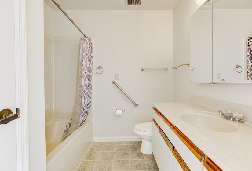 Full bath with shower / bath combination with curtain and vanity