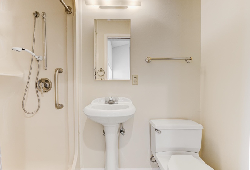 Full bath featuring toilet and a shower