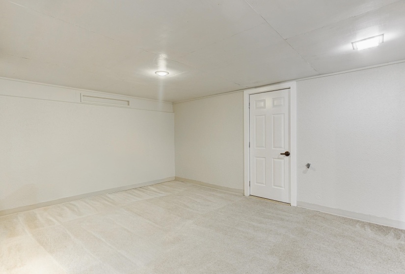 Empty room with light carpet and baseboards