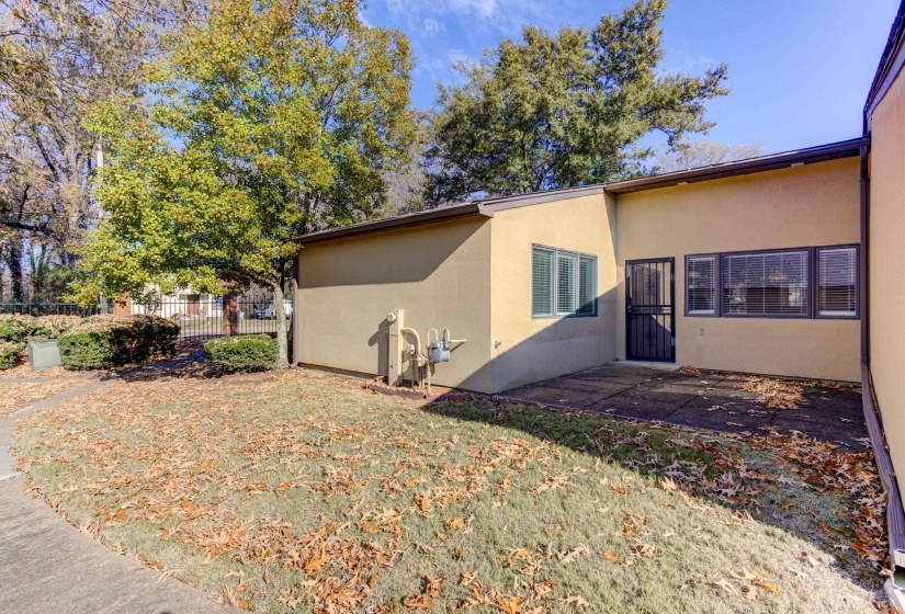View of side of home featuring stucco siding and a patio area