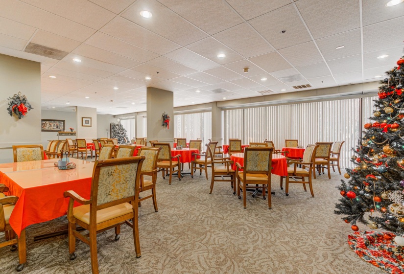 Dining space with light colored carpet, a paneled ceiling, and recessed lighting