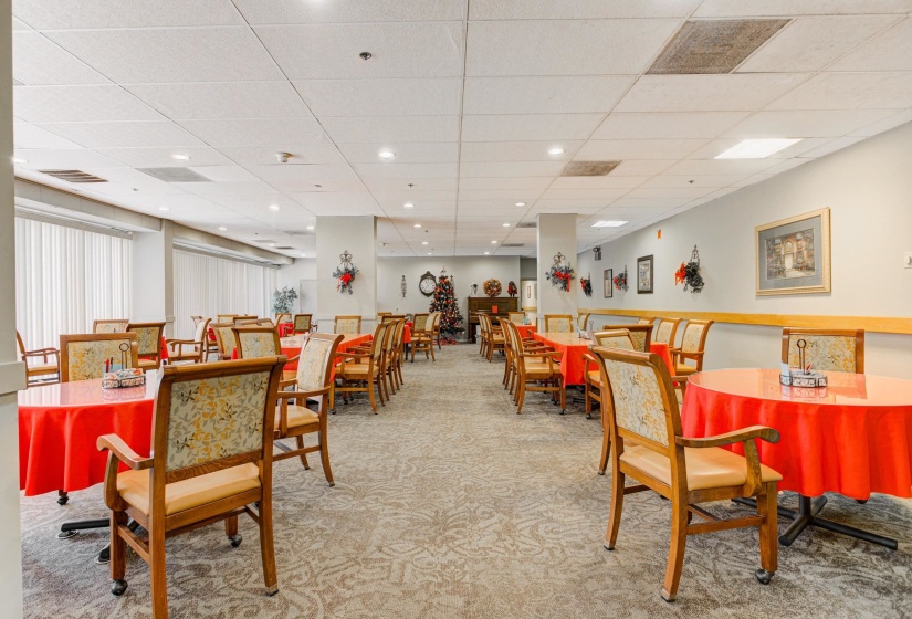 Dining room with light carpet and a drop ceiling