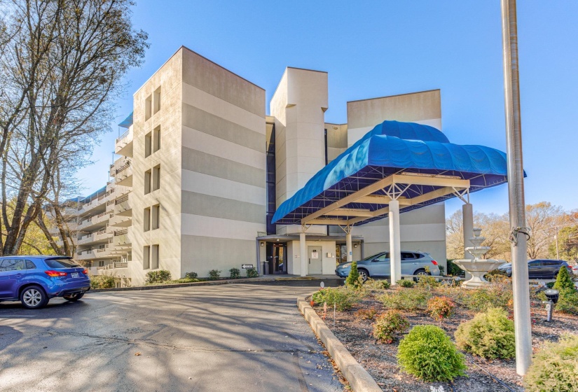 View of apartment building / complex with uncovered parking