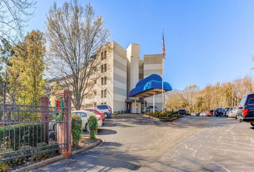 View of property featuring uncovered parking