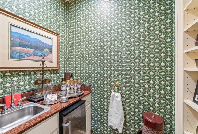 Bathroom featuring vanity, wallpapered walls, and wine cooler