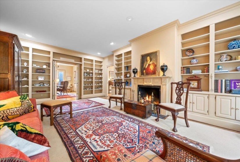 Living area with built in shelves, a high end fireplace, crown molding, carpet floors, and recessed lighting