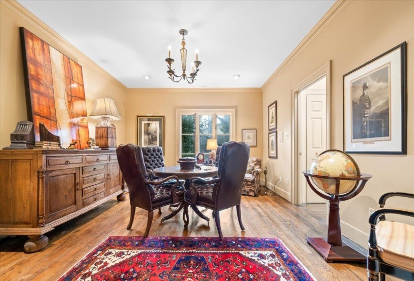 Dining area featuring a chandelier, ornamental molding, and light wood-type flooring