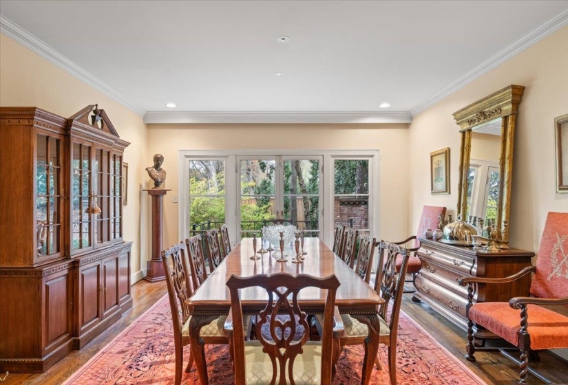 Dining space with wood finished floors, crown molding, and recessed lighting