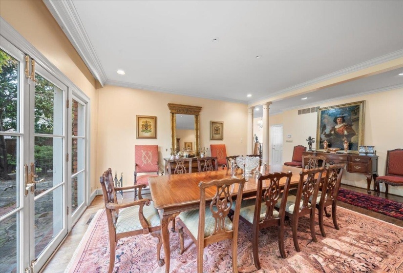 Dining space featuring decorative columns, ornamental molding, and recessed lighting