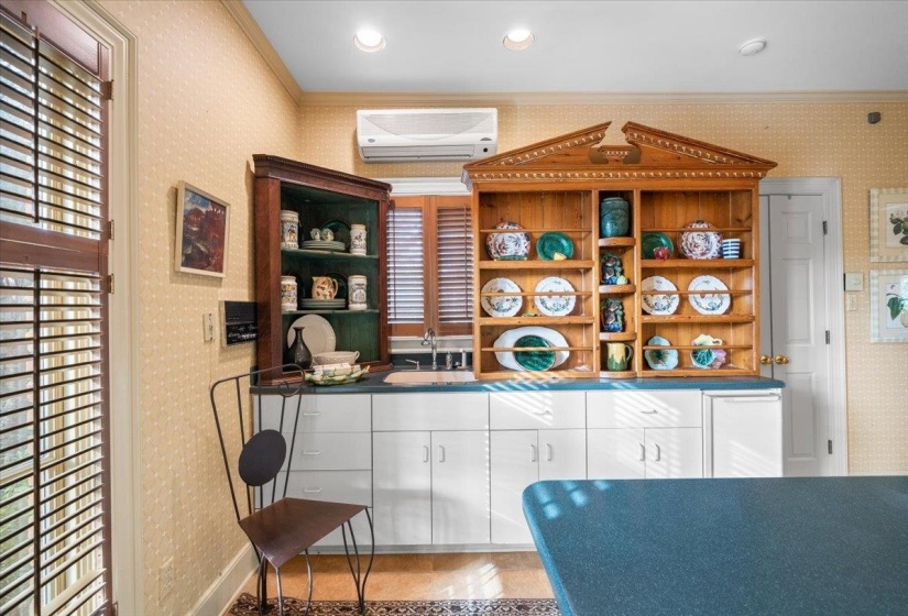 Bar with wallpapered walls, open shelves, white cabinetry, dark countertops, and a wall unit AC